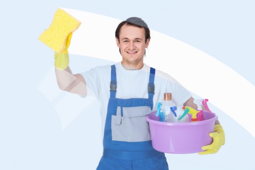 Cleaner working in a modern London apartment kitchen