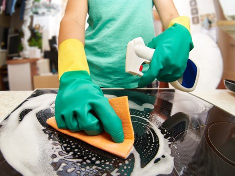 Experienced cleaner polishing bathroom surfaces in London